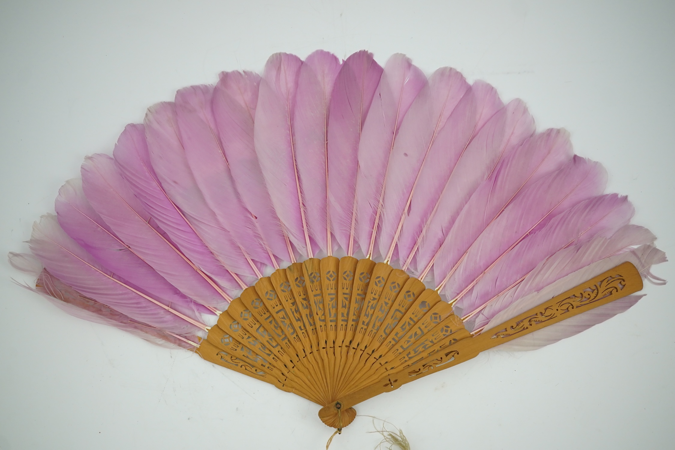 Three 19th century Chinese feather fans: One a carved bone brise black feather fan together with two similar carved sandalwood feather fans, two fans have hand painted decoration on the feathers both sides, the pink feat